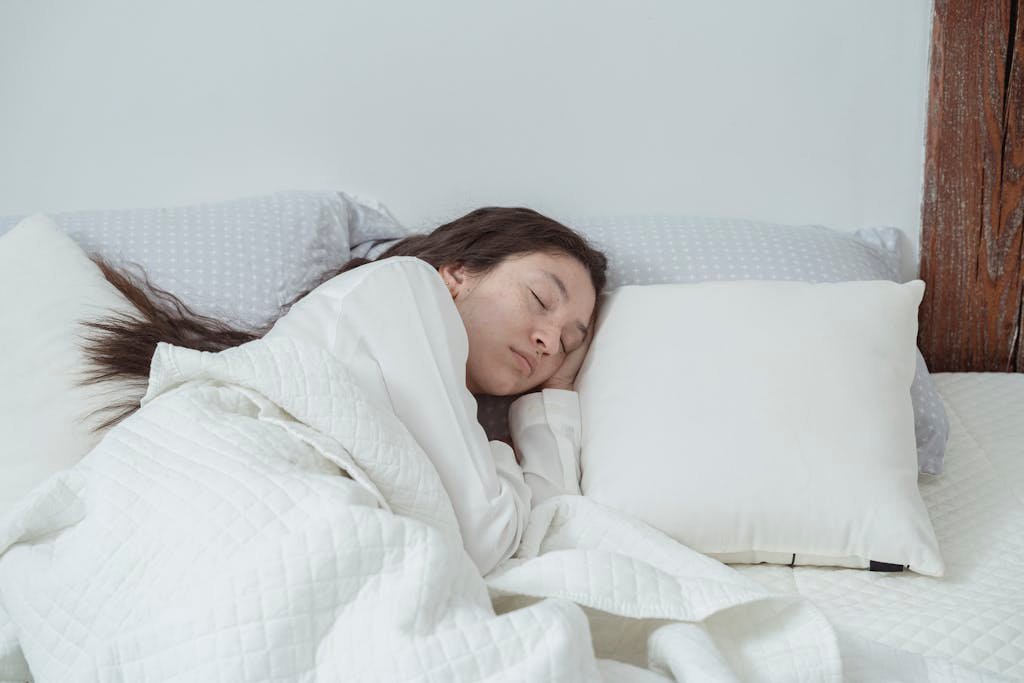 A serene image of a woman peacefully sleep inn hotels, light-filled bedroom.